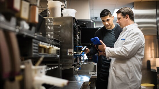 Ecolab employee with tablet showing customer digital technology solutions